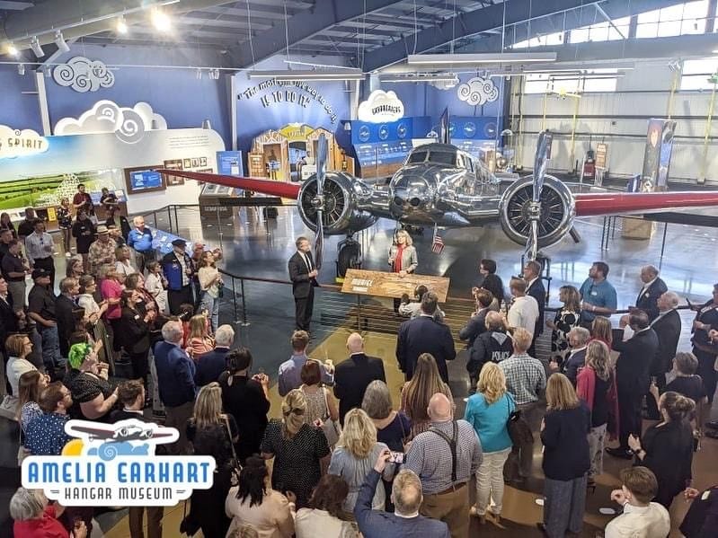 Crowd in Amelia Earhart Museum Gallery toasting during grand opening
