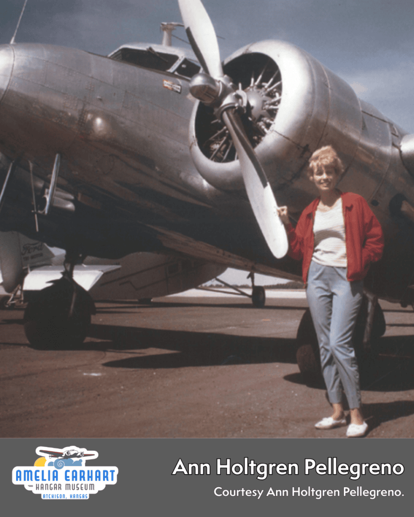 Ann Holtgren Pellegreno standing in front of Lockheed Electra 10-E airplane